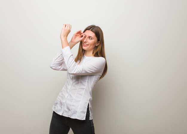 Young russian girl making the gesture of a spyglass