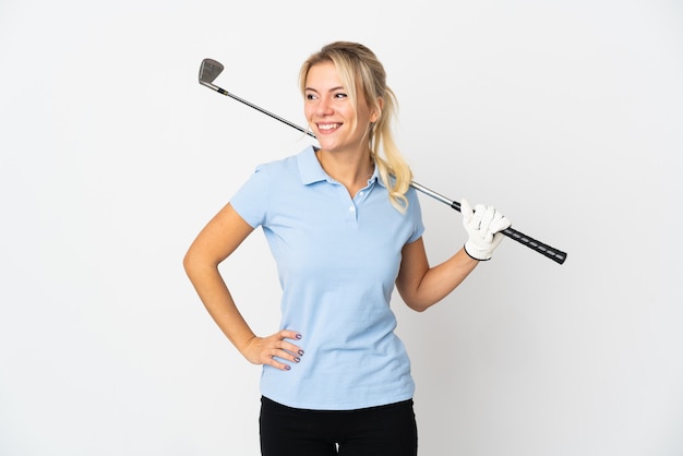 Young Russian golfer woman isolated on white wall posing with arms at hip and smiling