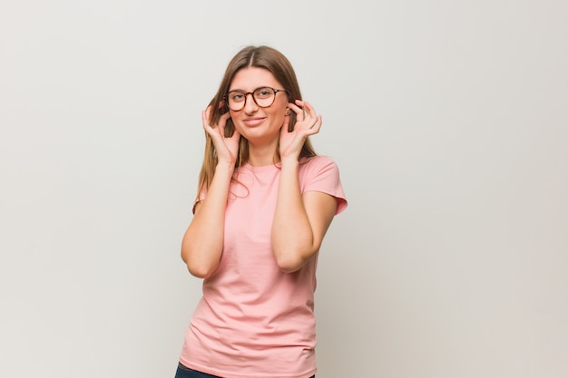 Young russian natural girl covering ears with hands