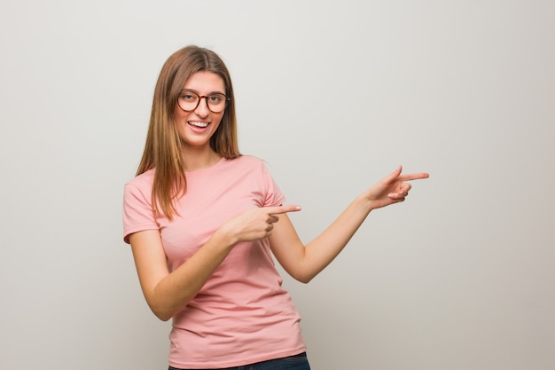 Young russian natural girl pointing to the side with finger