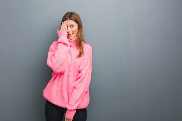 Young russian natural girl shouting happy and covering face with hand