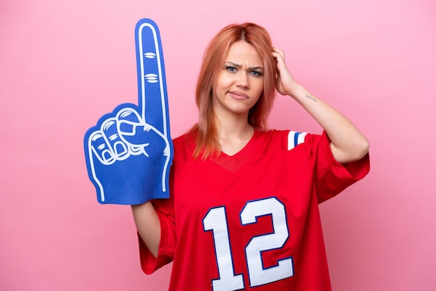 Photo young russian rugby fan girl isolated on pink background having doubts