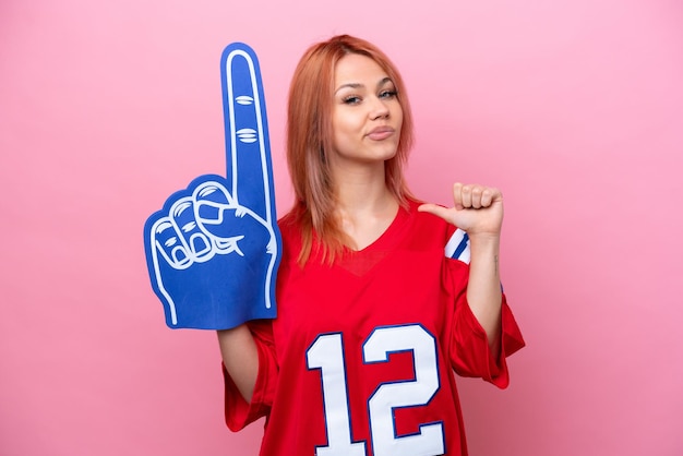 Young Russian rugby fan girl isolated on pink background proud and selfsatisfied