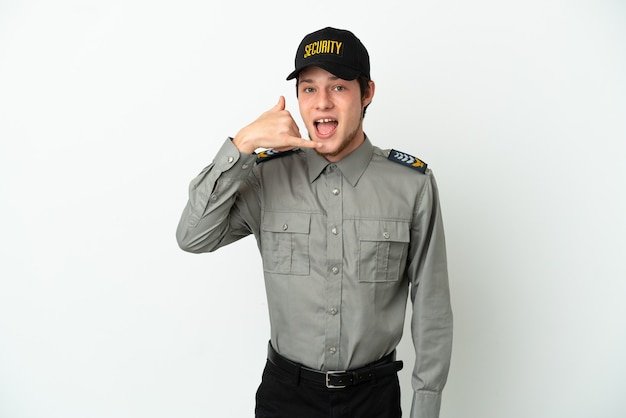 Young Russian security man isolated on white background making phone gesture. Call me back sign