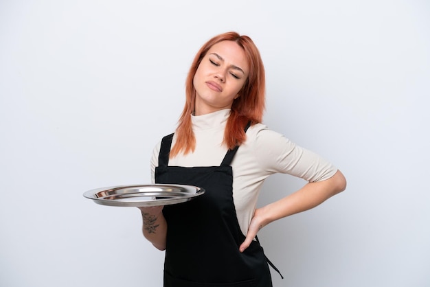 Young Russian waiter with tray isolated on white background suffering from backache for having made an effort