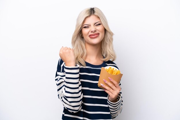 Young Russian woman catching french fries isolated on white background celebrating a victory