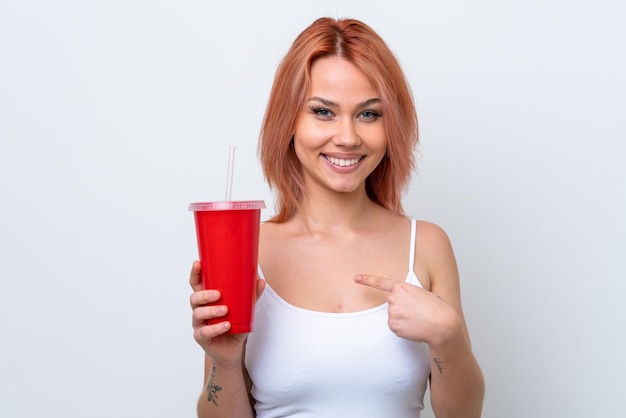 Young Russian woman holding soft drink isolated on white background with surprise facial expression