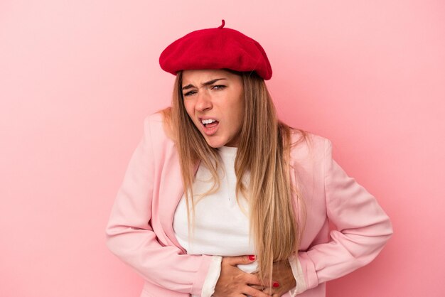 Young Russian woman isolated on pink background covering mouth with hands looking worried.