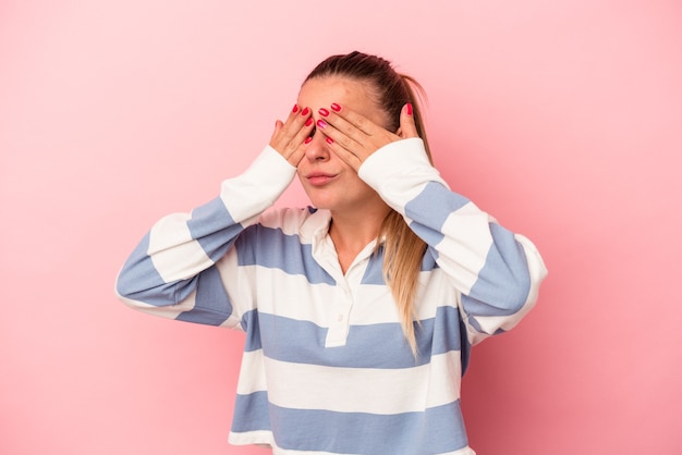 Photo young russian woman isolated on pink background having a head ache, touching front of the face.