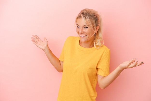 Young Russian woman isolated on pink background joyful laughing a lot. Happiness concept.