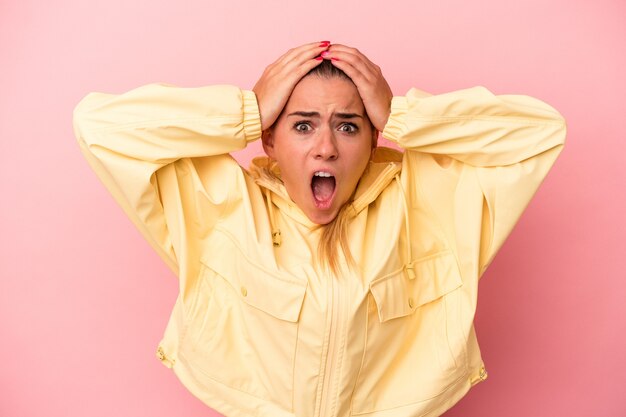 Young Russian woman isolated on pink background surprised and shocked.