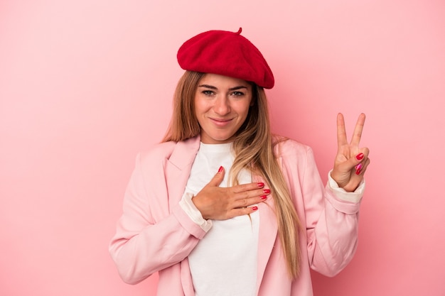 Young Russian woman isolated on pink background thinking and looking up, being reflective, contemplating, having a fantasy.