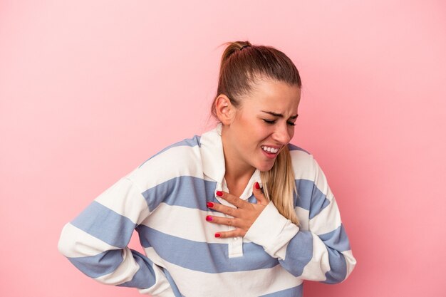 Photo young russian woman isolated on pink background with fingers on lips keeping a secret.