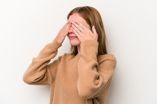 Young russian woman isolated on white background afraid covering eyes with hands