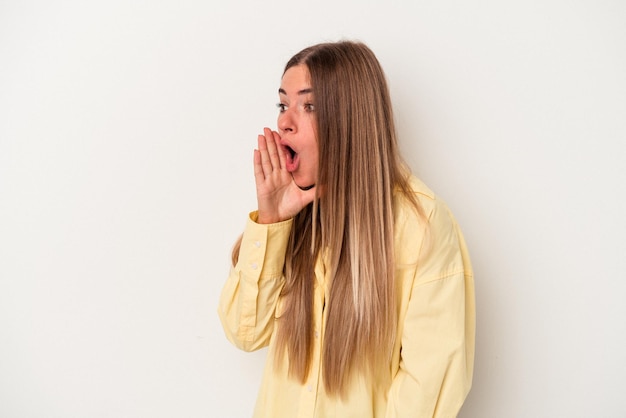 Young Russian woman isolated on white background being shocked because of something she has seen.