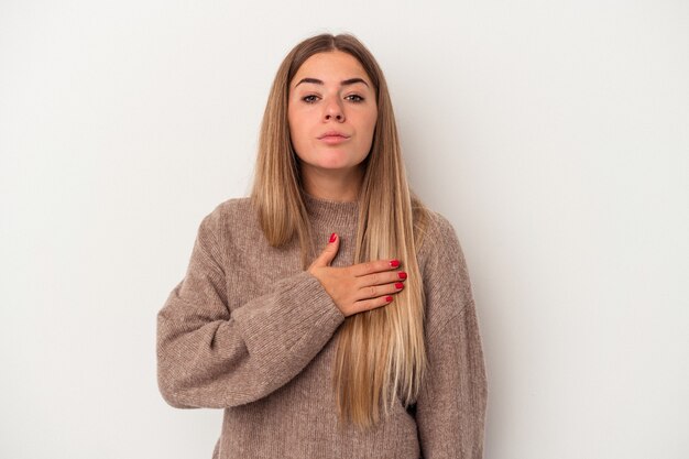 Young Russian woman isolated on white background covering ears with fingers, stressed and desperate by a loudly ambient.