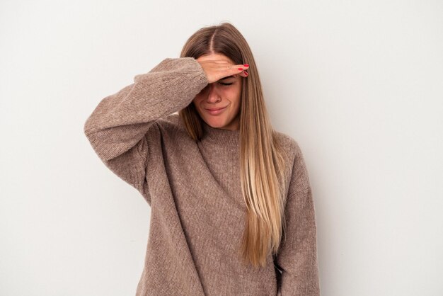 Young Russian woman isolated on white background holding something with palms, offering to camera.