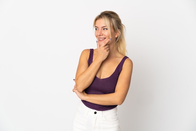 Young Russian woman isolated on white background looking to the side and smiling