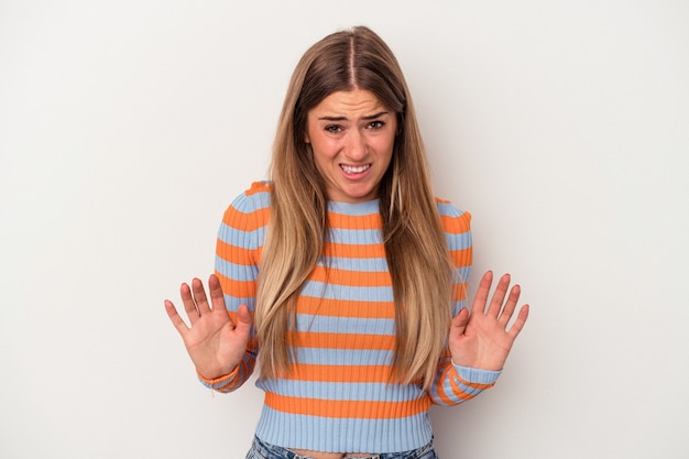 Young Russian woman isolated on white background rejecting someone showing a gesture of disgust.