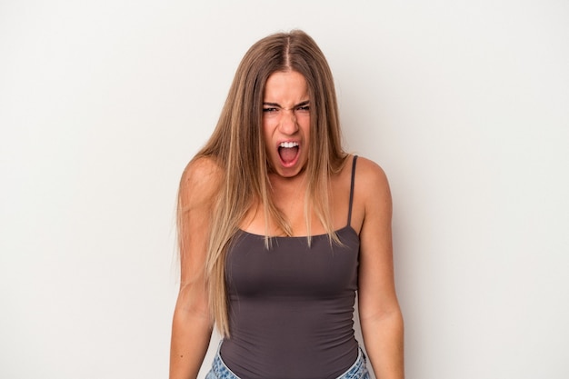 Young Russian woman isolated on white background shouting very angry, rage concept, frustrated.
