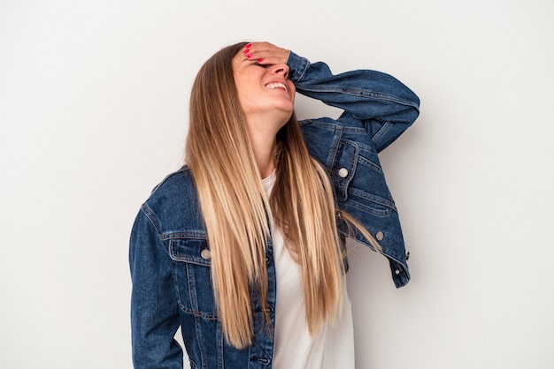 Young Russian woman isolated on white background shrugs shoulders and open eyes confused.