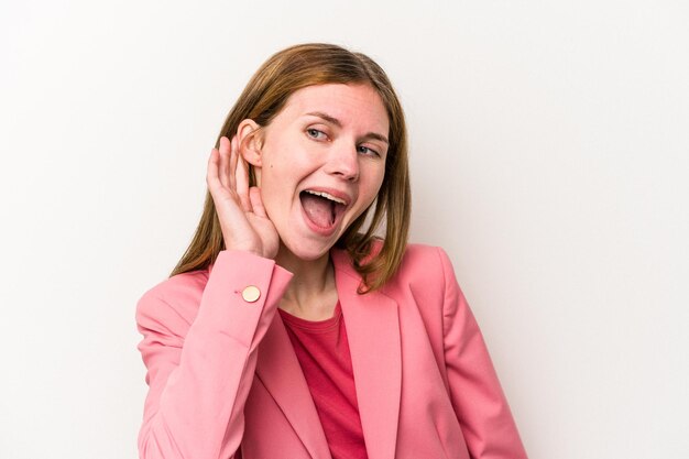 Young russian woman isolated on white background trying to listening a gossip