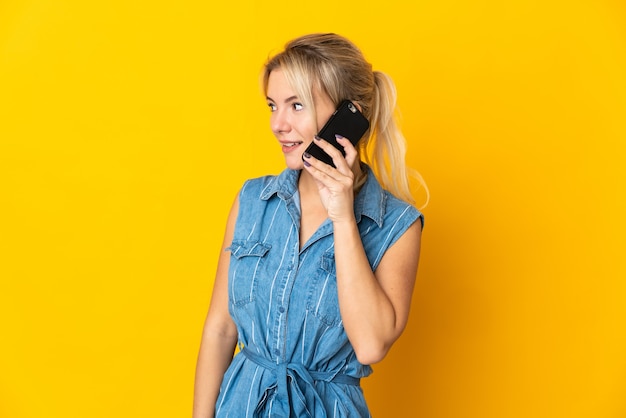 Young Russian woman isolated on yellow background 