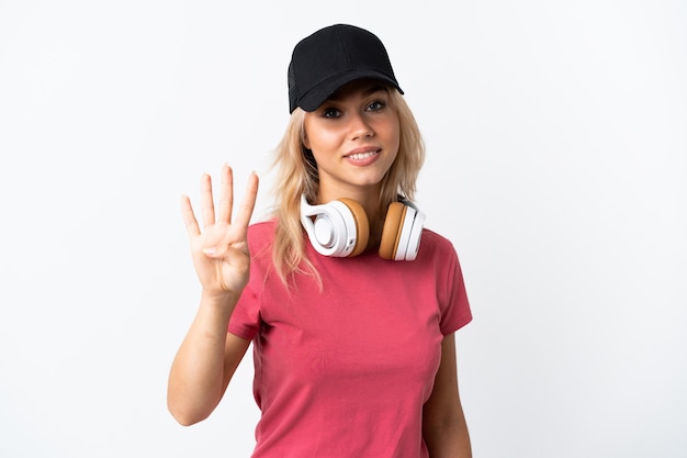 Young Russian woman listening music isolated on white happy and counting four with fingers