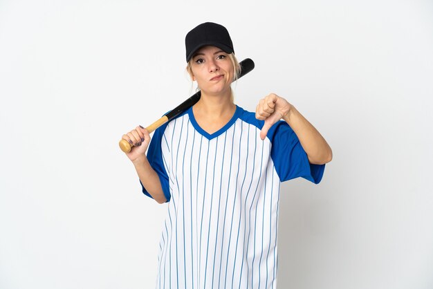 Young Russian woman playing baseball isolated on white background showing thumb down with negative expression