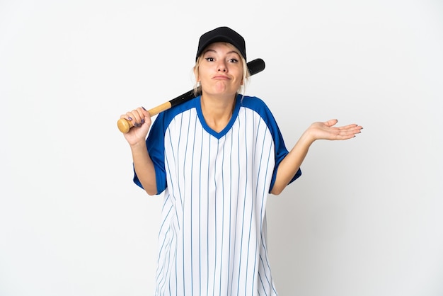 Young Russian woman playing baseball isolated on white having doubts while raising hands