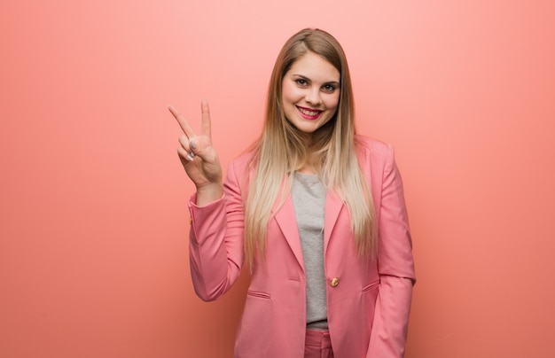 Young russian woman wearing pajama showing number two