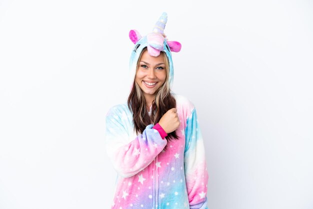 Young Russian woman wearing a unicorn pajama isolated on white background celebrating a victory