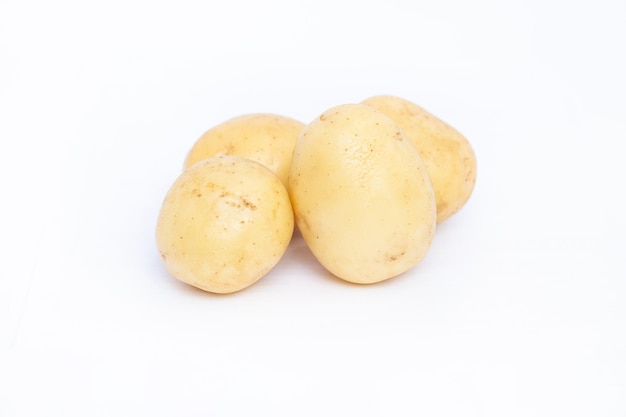 Young rustic raw potato on white background