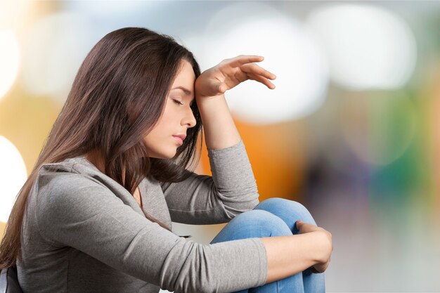 Young sad woman on background