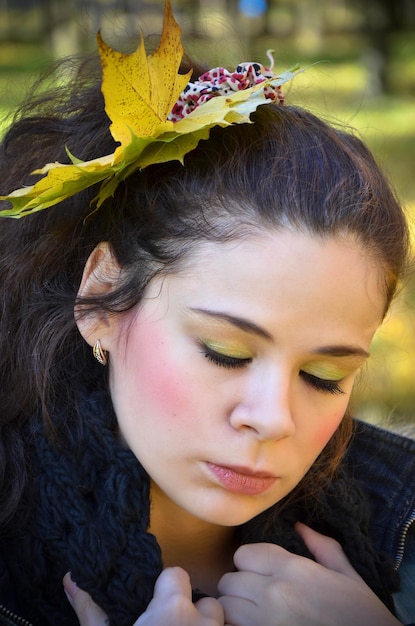 Young sad woman with leaves