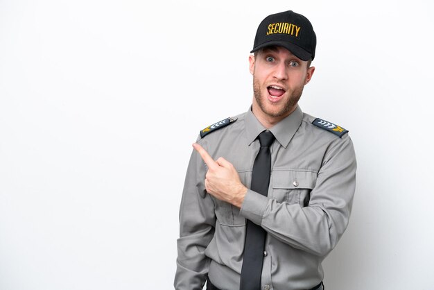 Young safeguard caucasian man isolated on white background surprised and pointing side