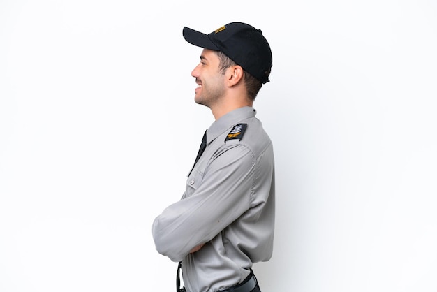 Young safeguard man over isolated white background in lateral position