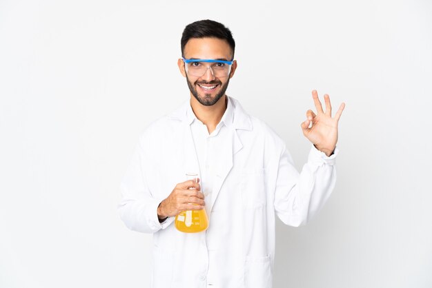 Young scientific man isolated showing ok sign with fingers