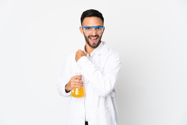 Young scientific man isolated on white background celebrating a victory