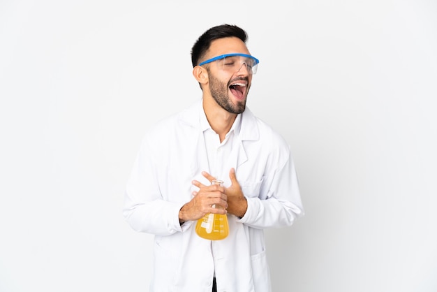 Young scientific man isolated on white wall smiling a lot