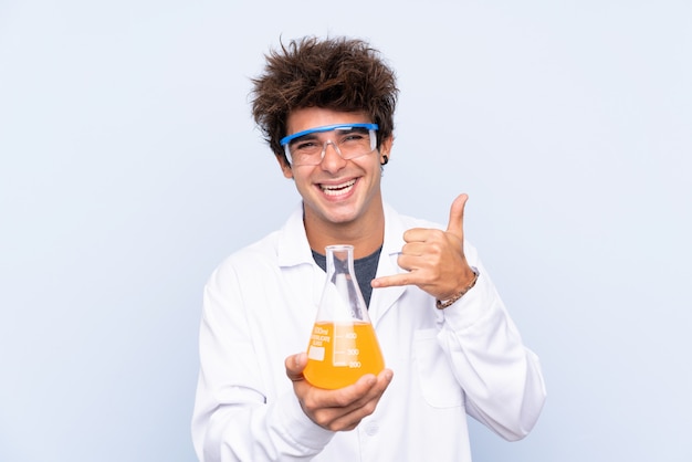 Young scientific man making phone gesture