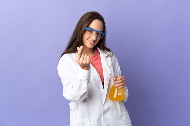 Young scientific woman over isolated making money gesture