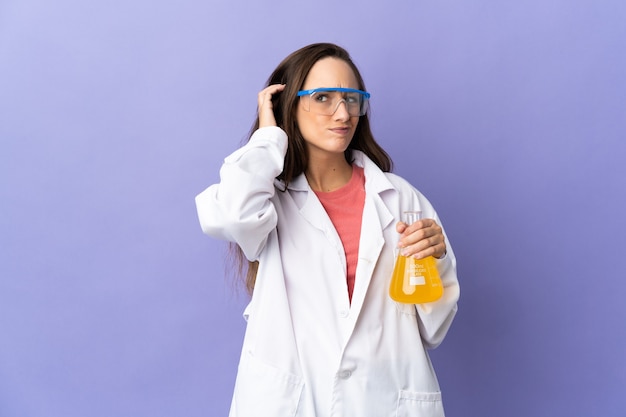 Young scientific woman over isolated wall having doubts