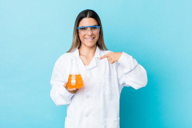 Young scientific woman person pointing by hand to a shirt copy space, proud and confident