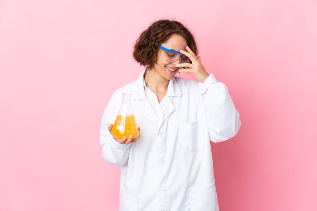 Young scientific woman posing isolated against the blank wall