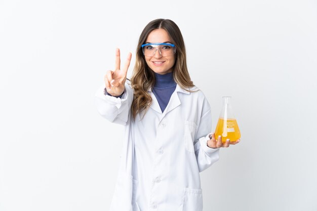 Young scientific woman posing isolated against the blank wall