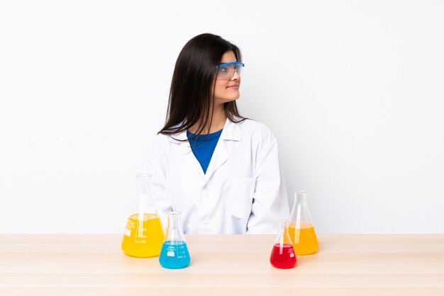 Young scientific woman in a table in lateral position