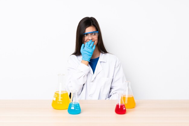 Young scientific woman in a table nervous and scared