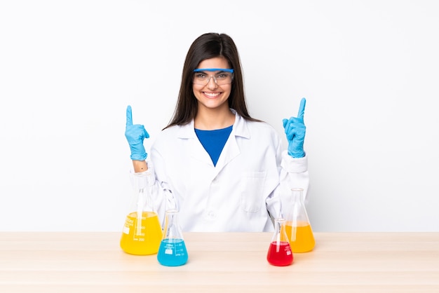 Young scientific woman in a table pointing up a great idea