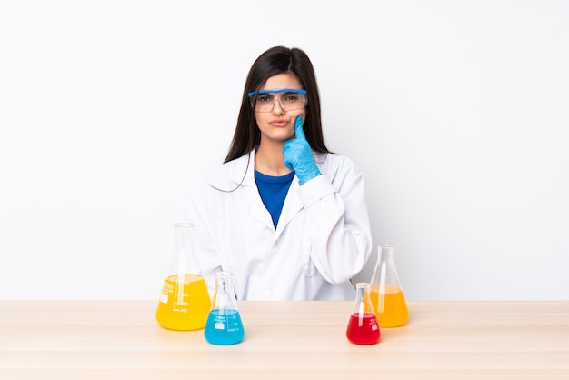 Young scientific woman in a table